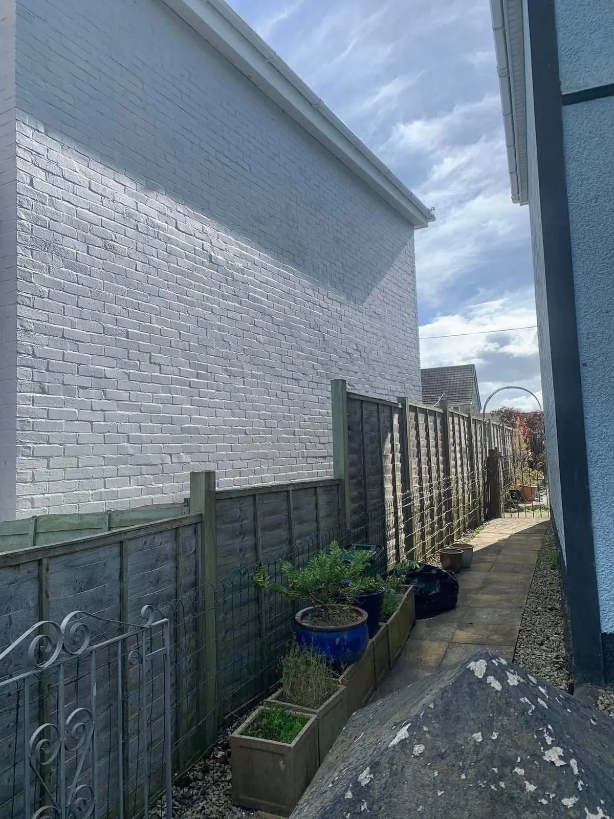 Freshly painted brick wall after preparation and masonry paint in South Molton