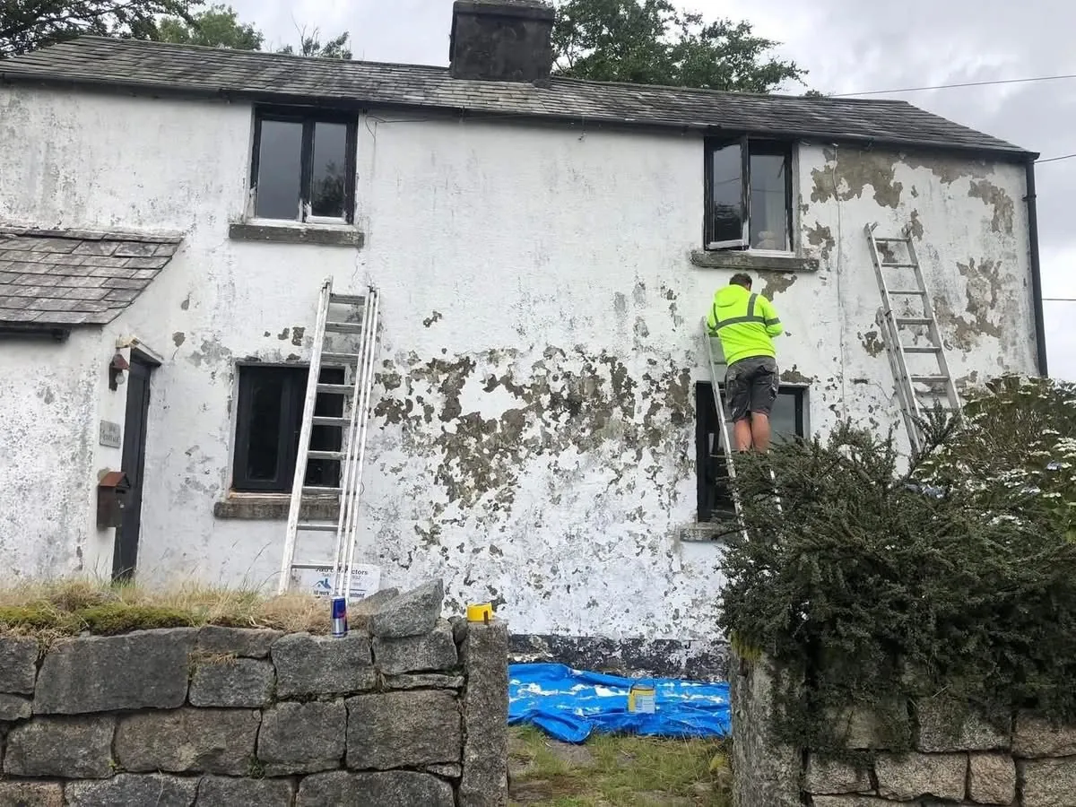 Cottage with blown, flaking render before repair in South Molton